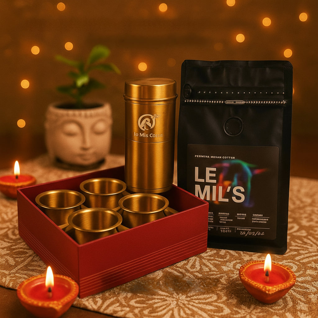Gold tea cups set, gold tea canister, and black coffee bag with 'Le Mil's' branding on a decorative surface with candles and a plant.